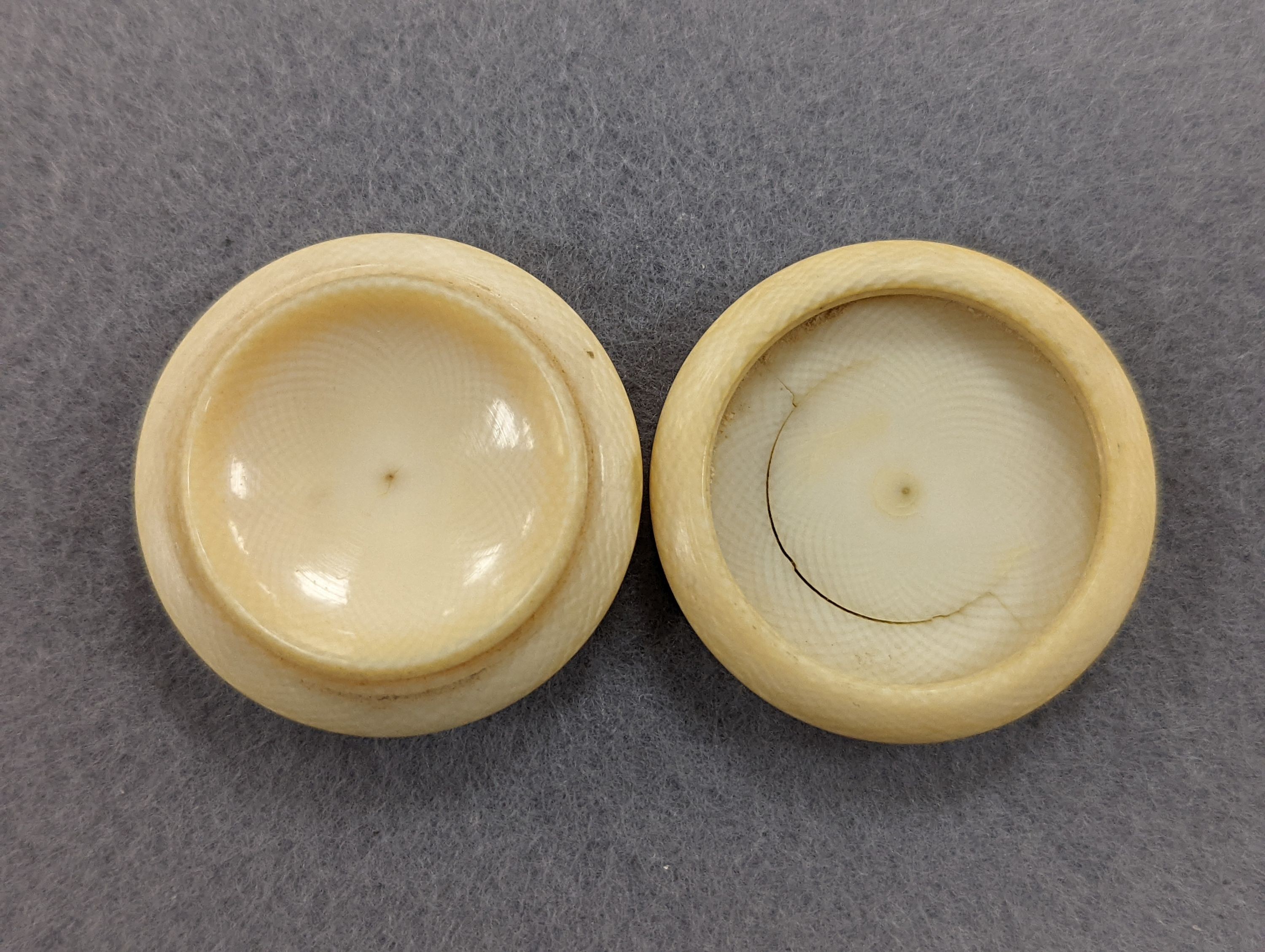 A pair of 19th century ivory balm pots, 3.75cm., a smallDieppe triptych figure, 6.5cm. a Meiji tiger brooch and a Dutch page marker.